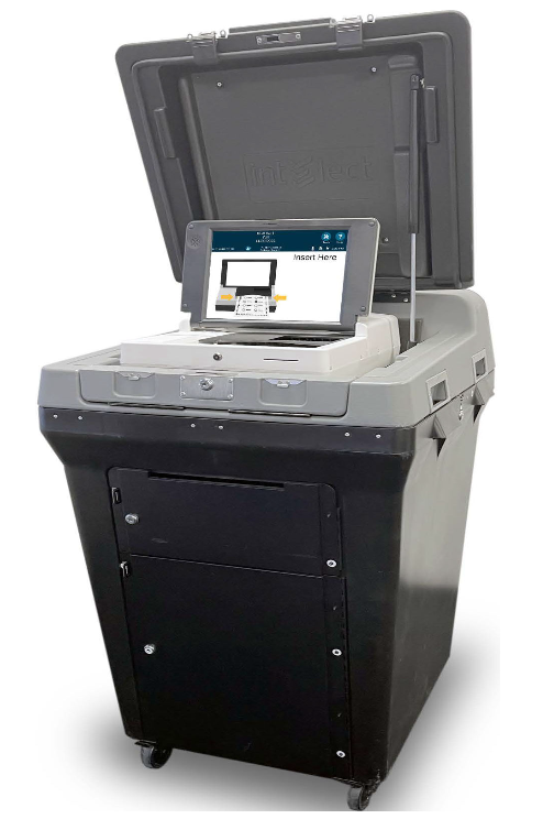 ES&S DS300 Gray scanner on black base with screen reading "Insert here." Base of scanner has doors with keyhole locks.