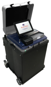 FVS-and-Ballot-Box-Uni-screen-602x1024 Black scanner with white touch screen reading "FreedomVote. Unisyn." Scanner has gray ballot slot and small black receipt printer below screen. Base of scanner is black.